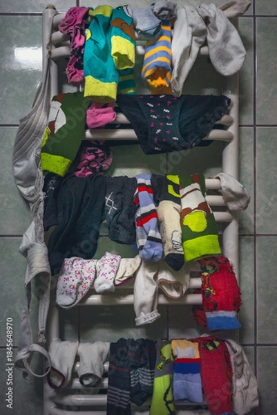 Fototapeta Children's socks and underpants on the radiator