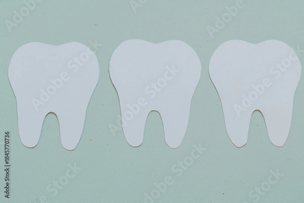 Obraz White teeth on a blue background. Flat view, top view, space for text. 