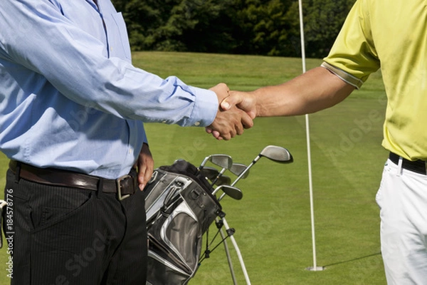 Obraz Golfer and caddy shaking hands