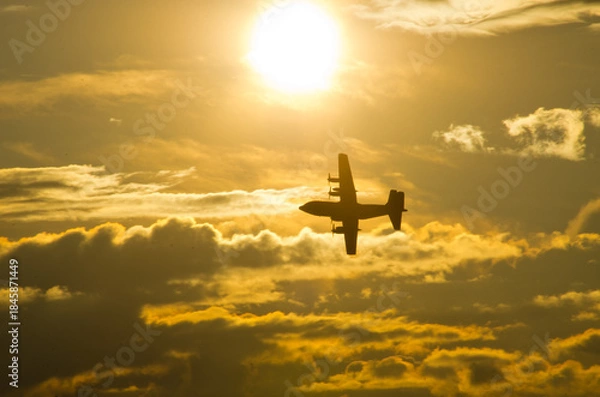 Obraz Airplane soaring through vibrant sunset cloudscape freely