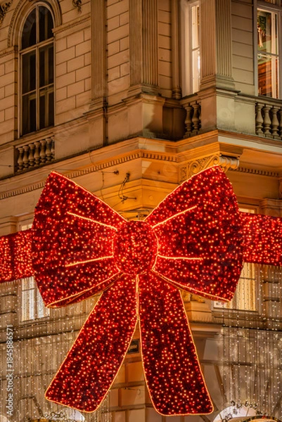 Obraz Christmas red bow decoration on historic building facade
