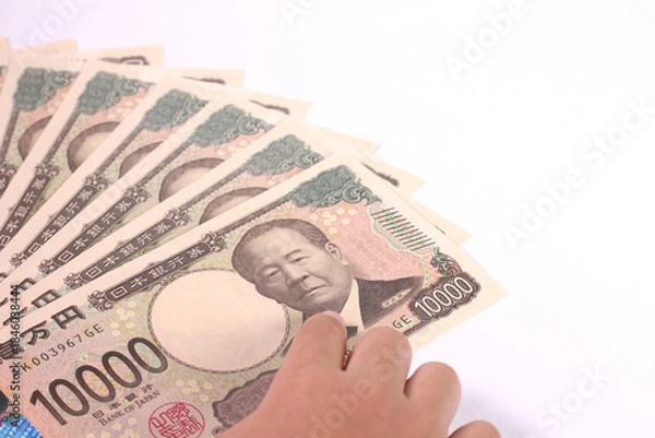 Obraz 1万円札を指差す子どもの手