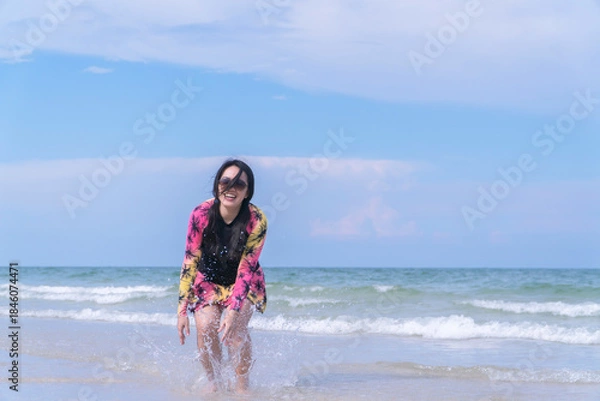 Fototapeta Happy Asian Woman Enjoying Beach Lifestyle in Swimsuit