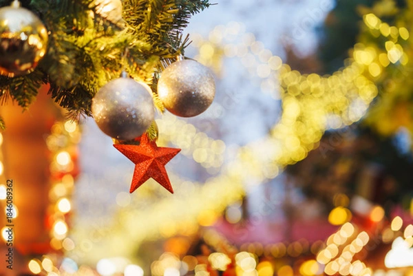 Obraz A Christmas tree at the festival market and romantic evening decorations