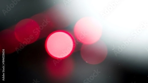 Fototapeta Abstract red bokeh lights on dark background with bright flare