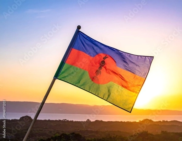Fototapeta A flag waving gently against a stunning sunset backdrop