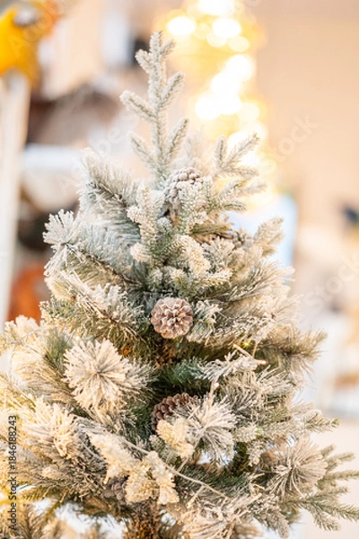 Obraz Blue Christmas tree with snowflakes falling on its branches