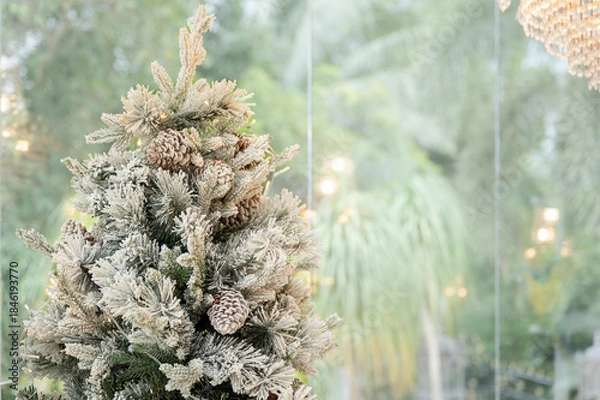 Obraz Blue Christmas tree with snowflakes falling on its branches