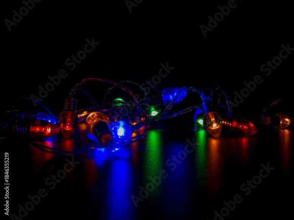Obraz Colorful String Lights Reflecting on Dark Surface
