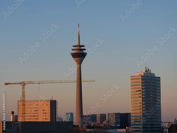 Fototapeta Series of three Pictures of the Rheinturm in Duesseldorf in the Dawn of Day - Different Lightnings. High quality photo