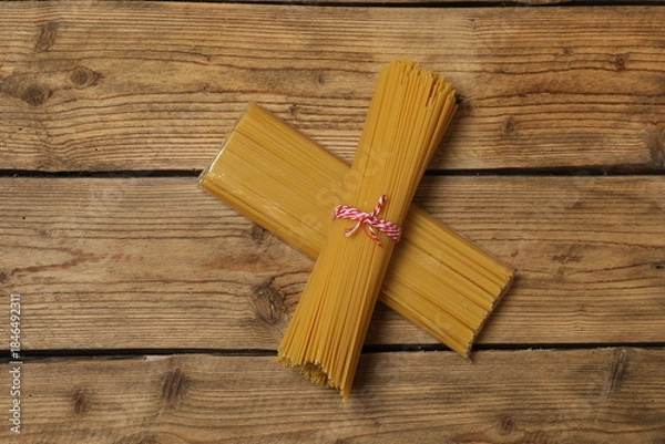Fototapeta Humanitarian aid. Different food products for donation in crate on wooden table