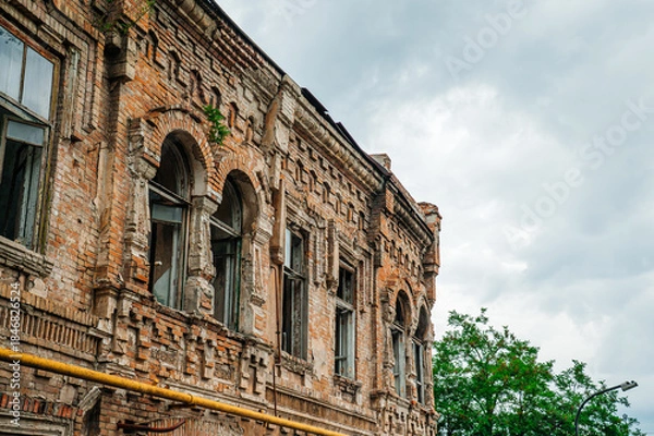 Obraz an old brick building with broken windows