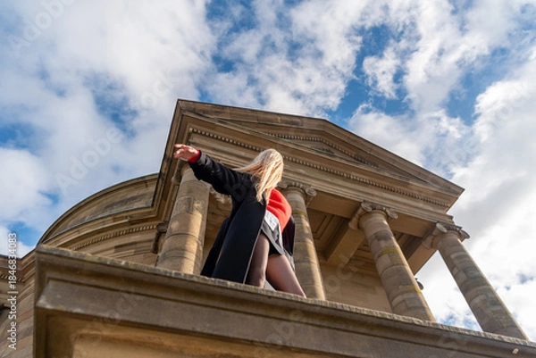 Fototapeta Woman with long hair enjoying the wind on a sunny winter day, low angle view