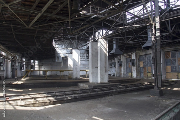 Fototapeta The empty building of the old train depot from the inside