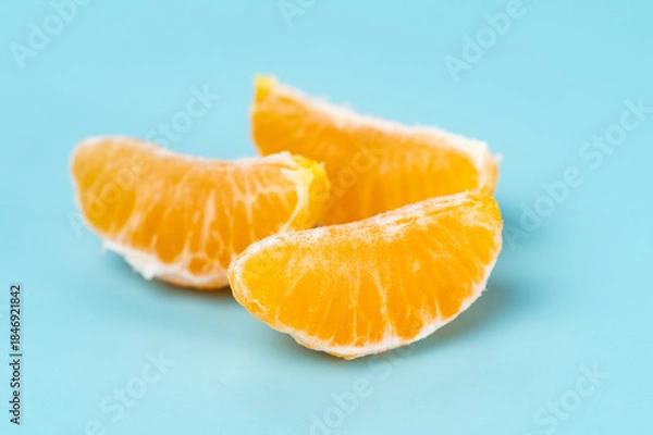 Obraz photo of tangerines on a blue background