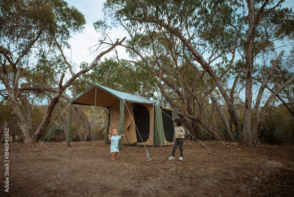 Obraz A joyful family is creating lasting memories while enjoying a delightful camping experience in a serene forest setting