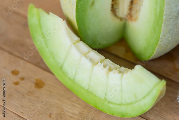 Fototapeta Fresh green melon on wood plate