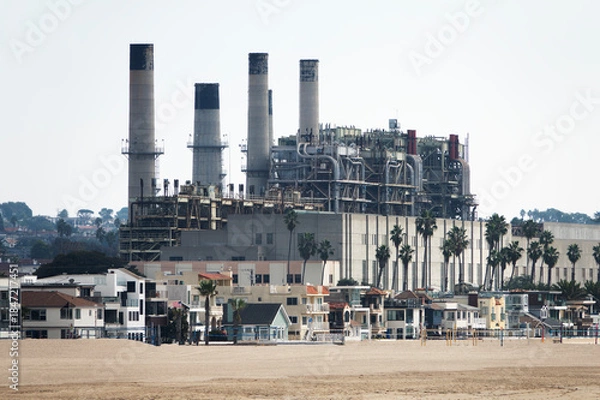Obraz View of Hermosa Beach homes and industrial power plant smokestacks in the South Bay area of Los Angeles County California.  