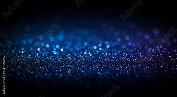 Obraz Blue glittering particles in dark background