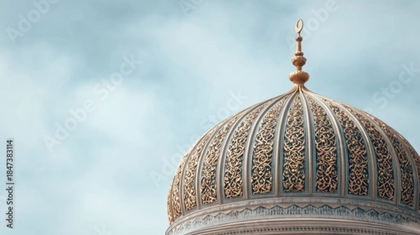 Obraz Close up view of an ornate Islamic mosque dome with intricate gold patterns against a soft blue sky