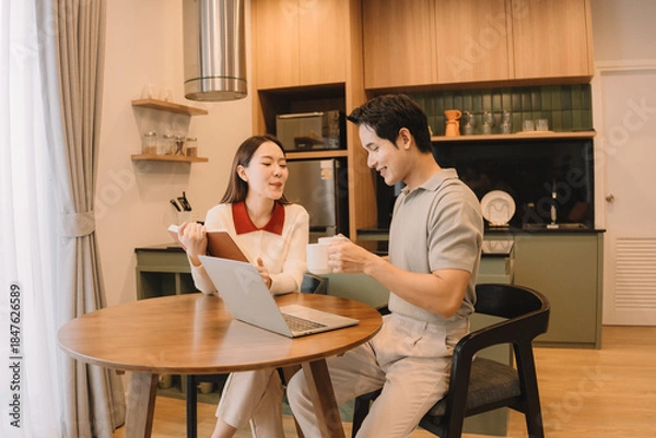 Fototapeta Happy Asian couple enjoying time together in their new home