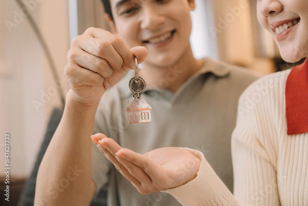 Fototapeta Happy Asian couple enjoying time together in their new home