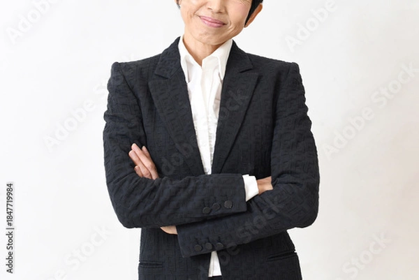 Obraz スーツ姿で腕組みをする笑顔の中高年のアジア人女性