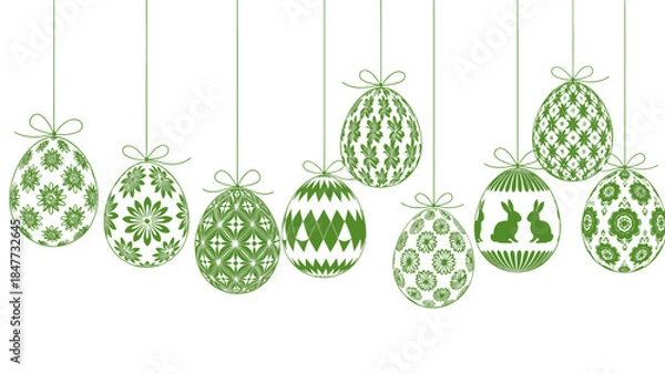 Fototapeta Green Easter eggs with intricate patterns hanging on ribbons, celebrating spring and holiday traditions.