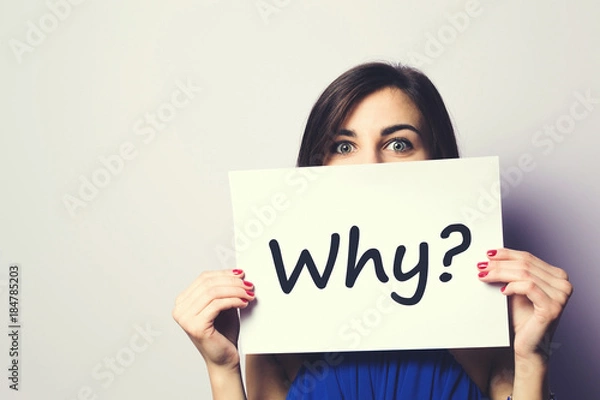 Fototapeta Girl holding a signboard with a question mark