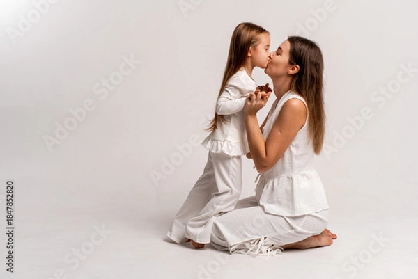 Fototapeta a newborn baby in its mother's arms, the mother soothes the baby before bedtime by rocking it to sleep