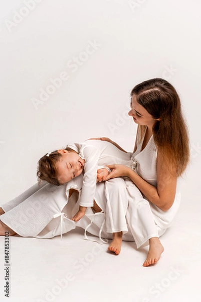Fototapeta a newborn baby in its mother's arms, the mother soothes the baby before bedtime by rocking it to sleep