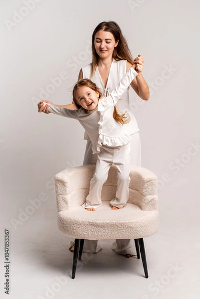 Fototapeta a newborn baby in its mother's arms, the mother soothes the baby before bedtime by rocking it to sleep