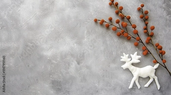 Obraz White reindeer figurine and orange berry branch on gray textured background