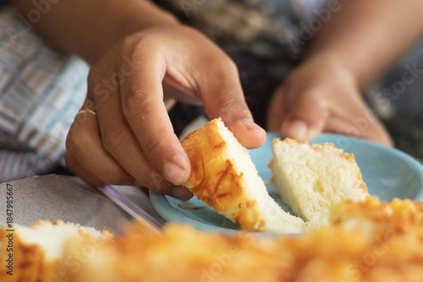 Obraz hands put pieces of cheese bread on a plate
