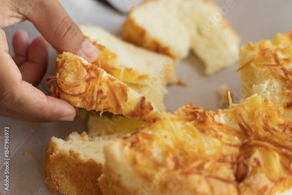 Obraz slice cheese cake pick up by hand