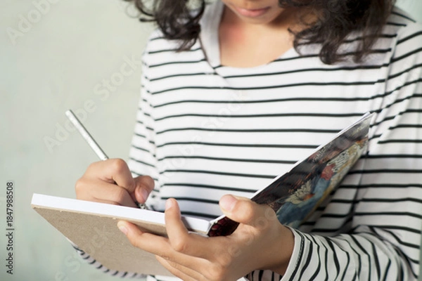 Obraz Grl writing a Journal on Clean White Background