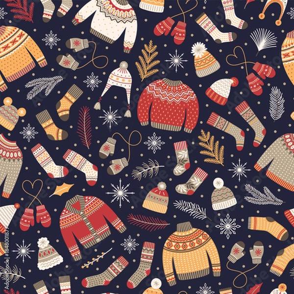 Fototapeta Seamless pattern with cozy winter knitted clothes. Christmas background with sweaters, socks, hats, and mittens on dark blue. Vector illustration.