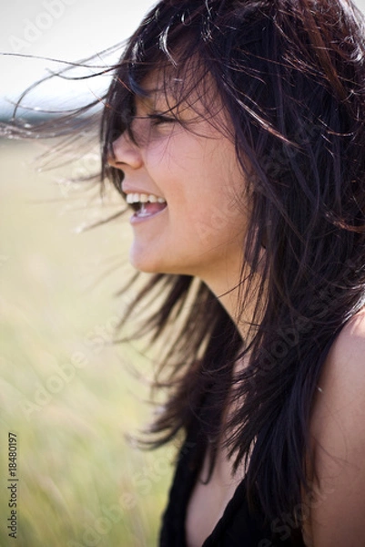 Fototapeta beautiful woman having fun in the wind