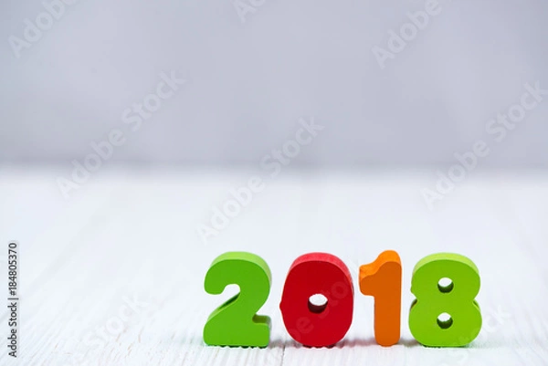 Obraz 2018 colorful wooden text on white wooden desk with Christmas decorations, Merry Christmas and happy new year concept.