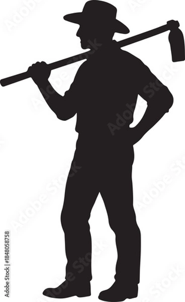 Obraz Silhouette of a hardworking farmer carrying a hoe over his shoulder