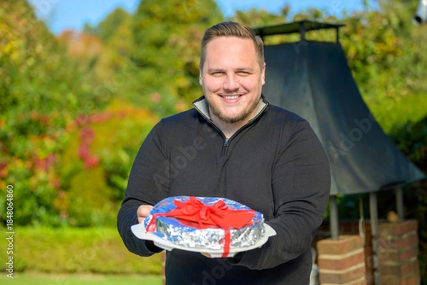 Obraz Smiling Man Presenting Wrapped Gift