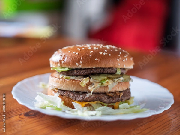 Obraz Double Cheeseburger with Fresh Vegetables on White Plate