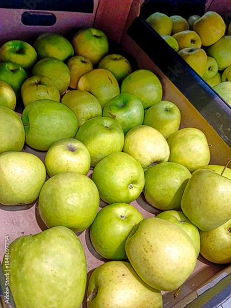 Obraz A box of green apples is on display