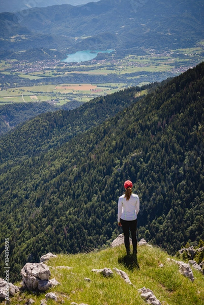 Fototapeta Young female is admiring majestic views with lake Bled in the distance in Slovenia