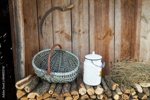 Obraz Objects of ancient village life near a wooden wall.