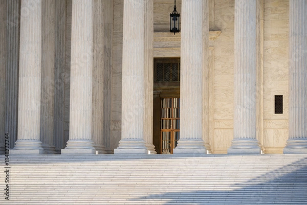 Fototapeta White stone columns express civic architecture. Supreme Court columns suggest justice and authority. Marble pillars highlight timeless architecture. Historic government building with massive columns.