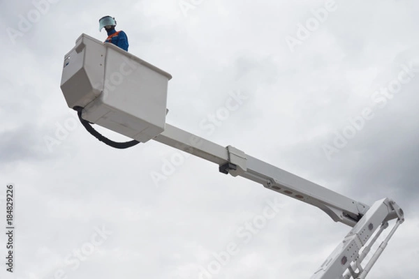Obraz An electrician on aerial platform
