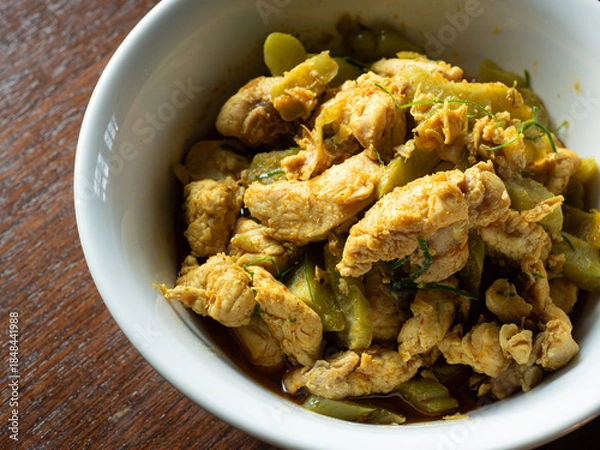 Obraz Thai stir fried chicken and bitter gourd with yellow curry