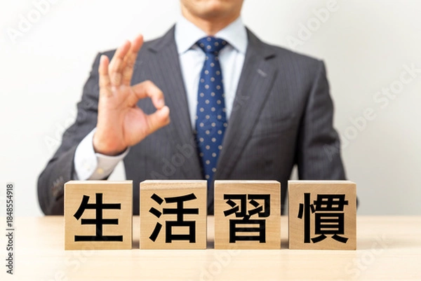 Fototapeta 「生活習慣」と書かれたブロックとOKポーズをするビジネスマン