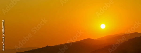 Obraz the sun rising behind a mountain